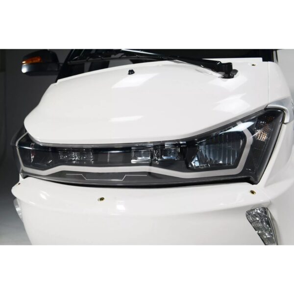 Pushpak 8000 front headlights close-up. Sleek design & advanced lighting technology.