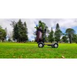 Live image showing the left side view of the Golf Skate Caddy GSC™ Tourer X Golf Cart Mobility Scooter, captured amidst the serene backdrop of a golf course, highlighting its functionality and suitability for navigating the greens.