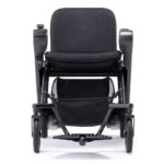 Front view of a black Whill Model F power wheelchair, highlighting its seat, armrests, and front wheels with a mesh storage basket underneath.