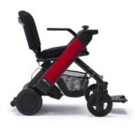 Whill Model F power wheelchair with red color armrests, durable wheels, and an integrated mesh storage basket.