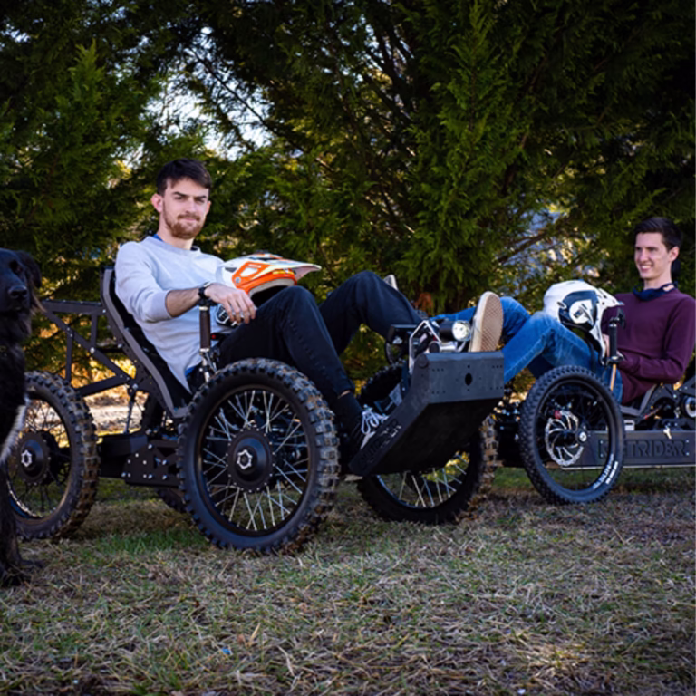 Rider outdoors on a 4x4 wheelchair fitted with 22 inch off road tires