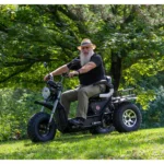 Man in straw hat riding black Daymak Boomerbeast 2D in a park.