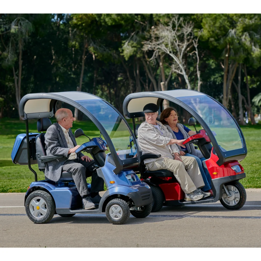 Live Style Image Side View of Blue Afiscooter S4 with Canopy Mobility Scooter, Red Afiscooter S3 Dual Seat Mobility Scooter with Canopy Golf Tires