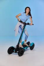 A Women standing on MIA SPYQE 2x4 electric scooter with strong suspension and wide tires designed for smooth and powerful urban riding shop the SPYQE now