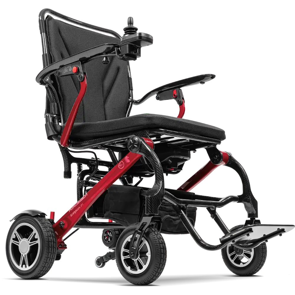 Forcemech Carbon F1 Lightweight Folding Power Wheelchair in red shown from a lower angle highlighting the frame wheels and footrest.