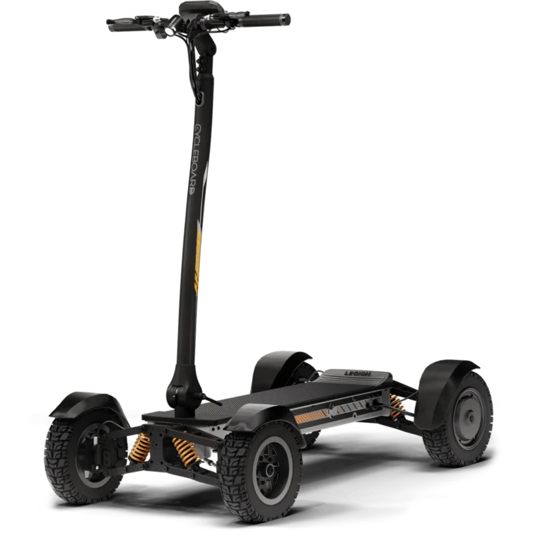 Gray four wheel stand up adult electric quad seen from a front three quarter angle