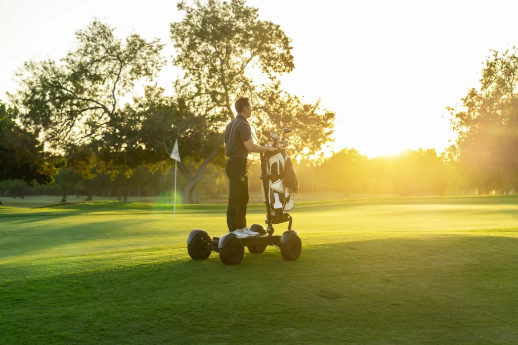 Man riding an off road electric Cycleboard X-Quad 3000 Golf scooter on a golf course explore easy golf course mobility today