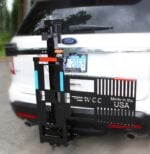 Model 101 Electric Tilt n Tote with folded wheelchair secured on platform