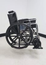 Folding manual wheelchair secured on the Tote Model 003 carrier side view