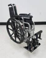 Folded wheelchair loaded on the Tote Model 003 three quarter view
