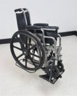 Folding wheelchair loaded and secured on the Tilt N Tote Model 001 carrier