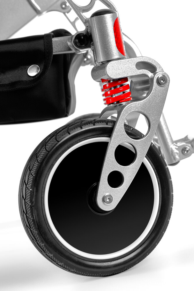 Porto Mobility Ranger Maestro XL reclining folding power wheelchair, front caster wheel with red coil spring close up