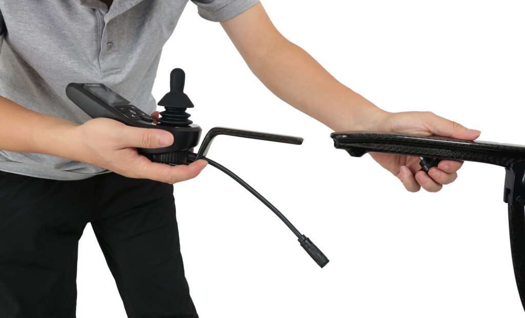 Porto Mobility Ranger Aero folding power wheelchair, joystick controller held off the armrest with its cable