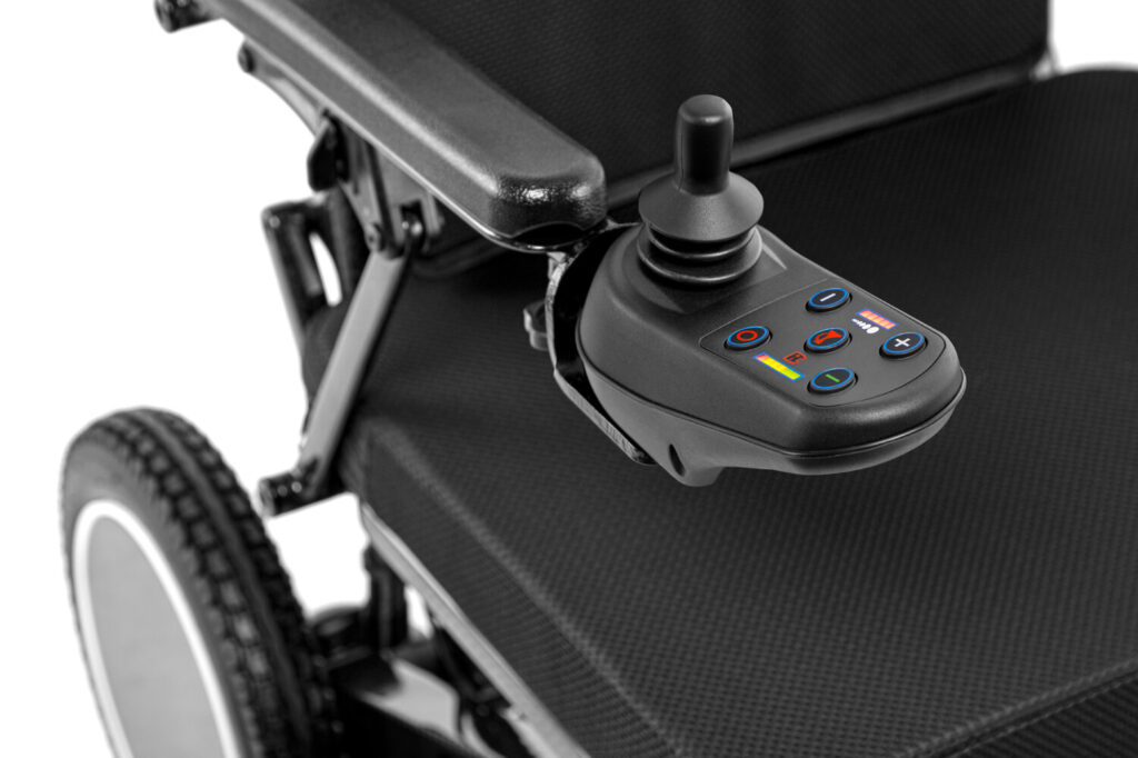 Porto Mobility Ranger SpacePro folding power wheelchair, joystick and armrest close up