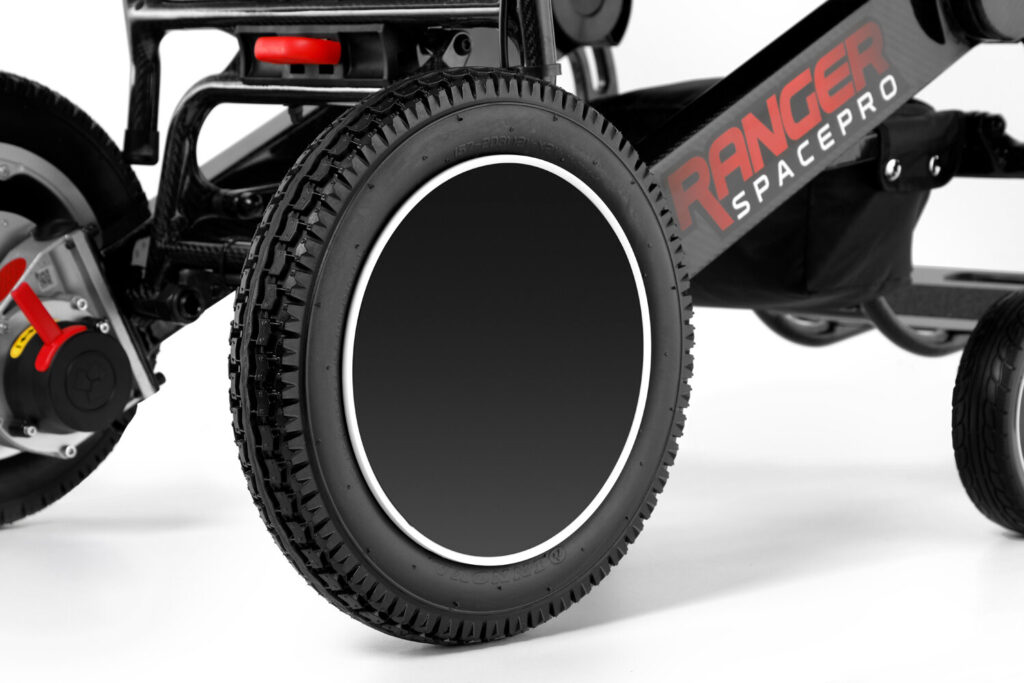 Porto Mobility Ranger SpacePro XL folding power wheelchair, rear wheel and tire close up