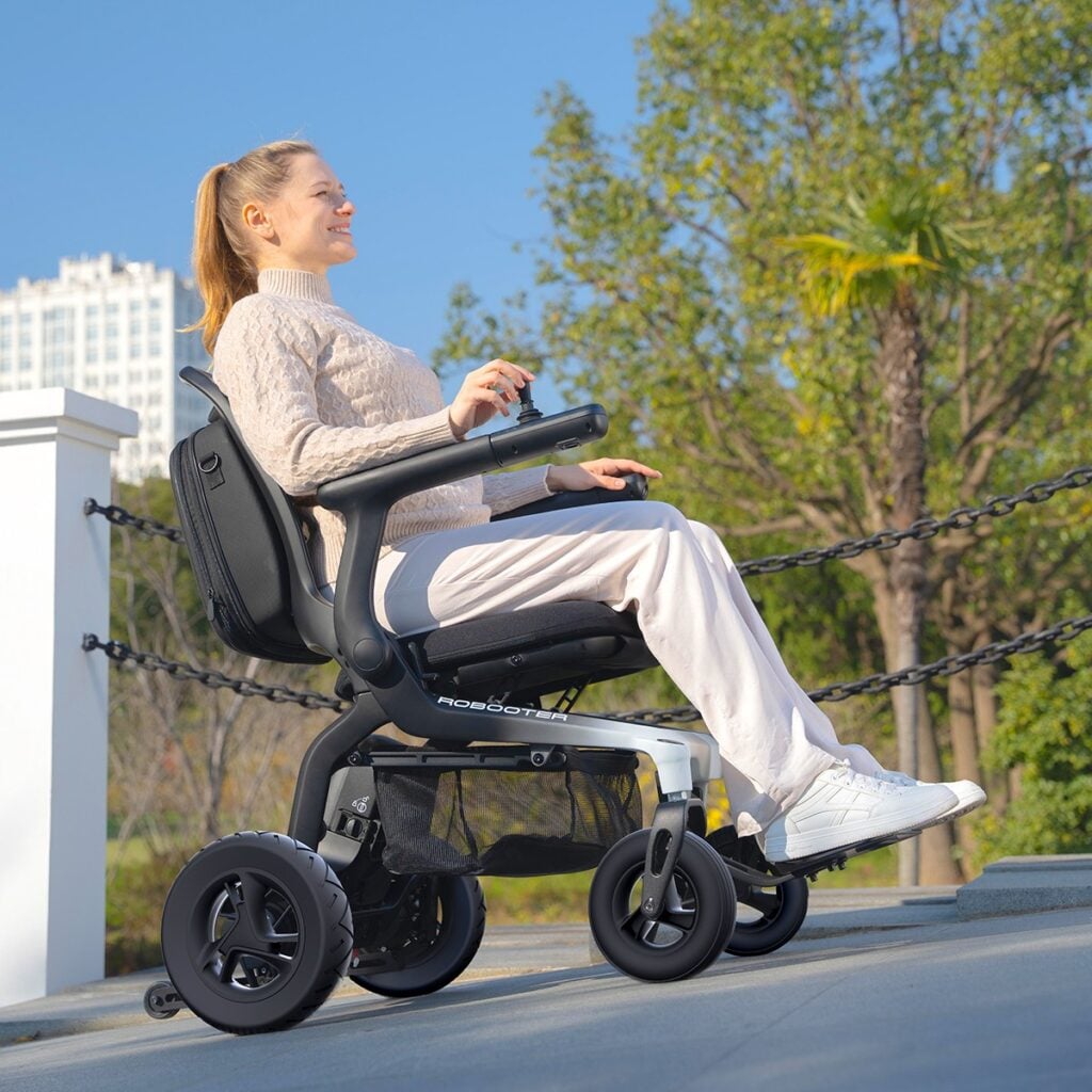 Woman riding a Robooter E80 on a paved outdoor path